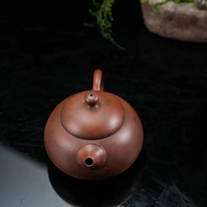 Top view of handmade Jianshui rounded red clay teapot