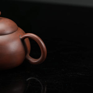 Top view of handmade Jianshui rounded red clay teapot