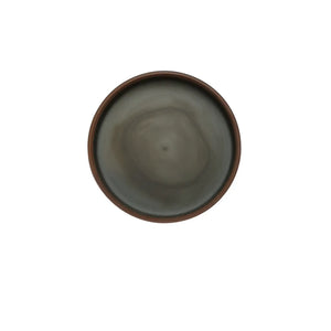 Top-down view of the interior of a handmade pottery tea cake storage box, showing a smooth, unglazed surface with natural clay tone variations.