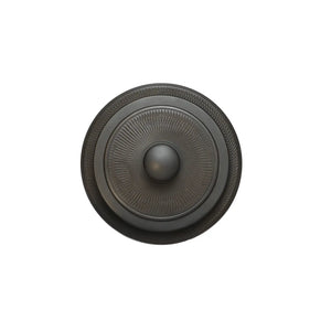 Top view of a Jianshui zitao tea canister lid featuring a raised center knob and finely carved radial texture