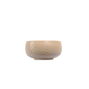 Handcrafted white clay teacup with a hammered texture, featuring a minimalist unglazed finish and a gently rounded form.