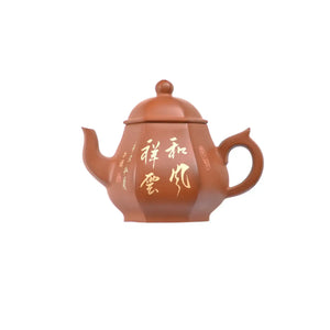 Jianshui zitao red clay hexagonal teapot featuring carved Chinese calligraphy, side view.