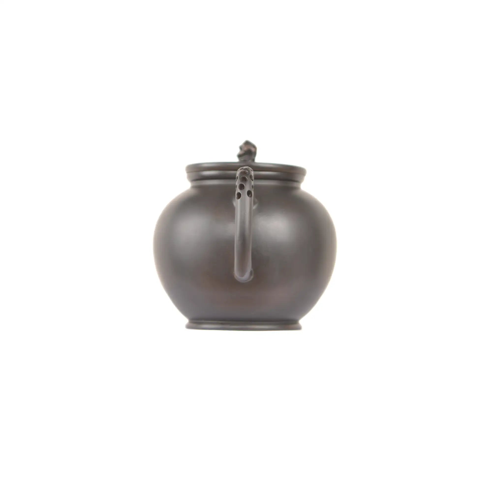 Jianshui zitao black clay teapot with rounded body, smooth finish, and perforated handle design, back view.