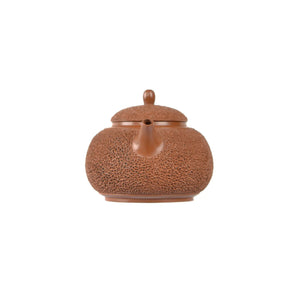 Jianshui zitao red clay needle-textured teapot, front view with spout.