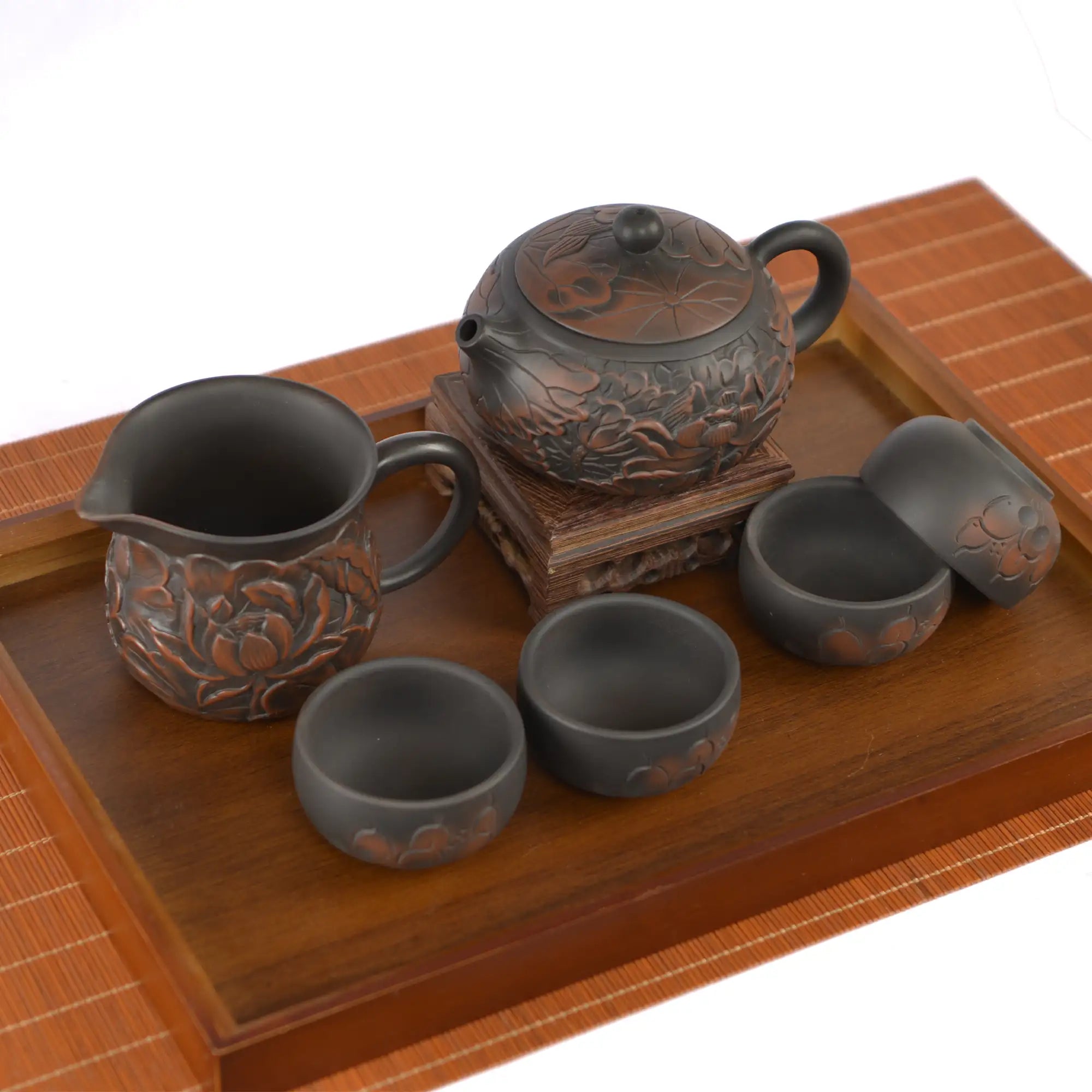 Jianshui zitao tea set featuring an all-over hand-carved lotus design, including one fairness pitcher and four tea cups