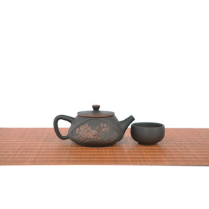 Handmade pottery Shi Piao teapot and one cup set with hand-carved peony design.
