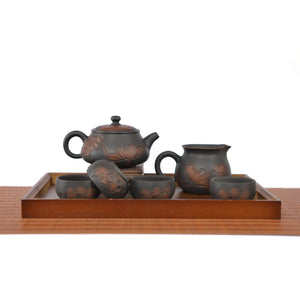 Handmade Shi Piao teapot set with line-carved lotus design, including teapot, fairness pitcher, and four tea cups on a wooden tray.