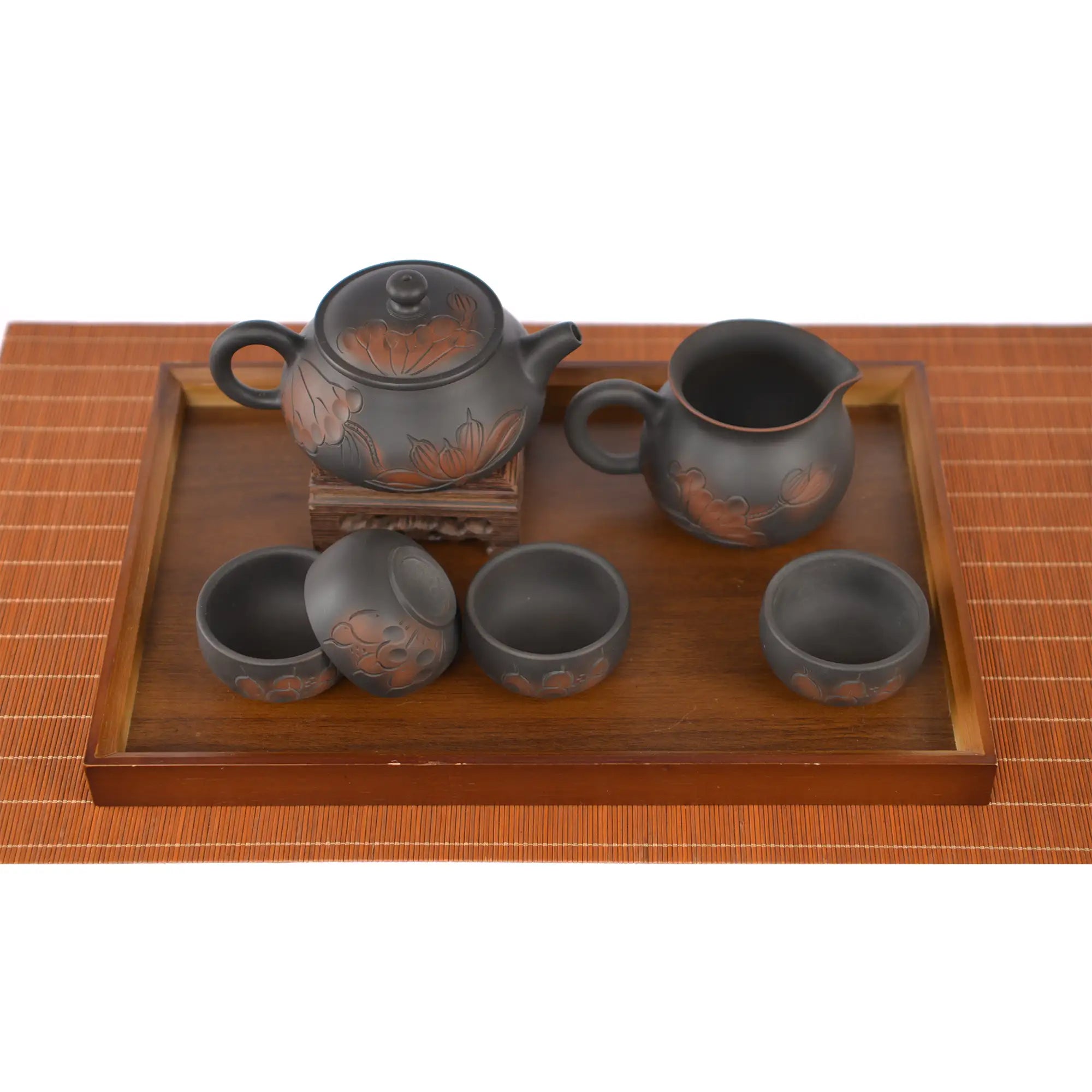 Hand-carved lotus Shi Piao tea set with teapot, fairness pitcher, and four tea cups arranged on a wooden tea tray.