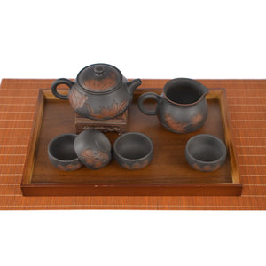 Hand-carved lotus Shi Piao tea set with teapot, fairness pitcher, and four tea cups arranged on a wooden tea tray.