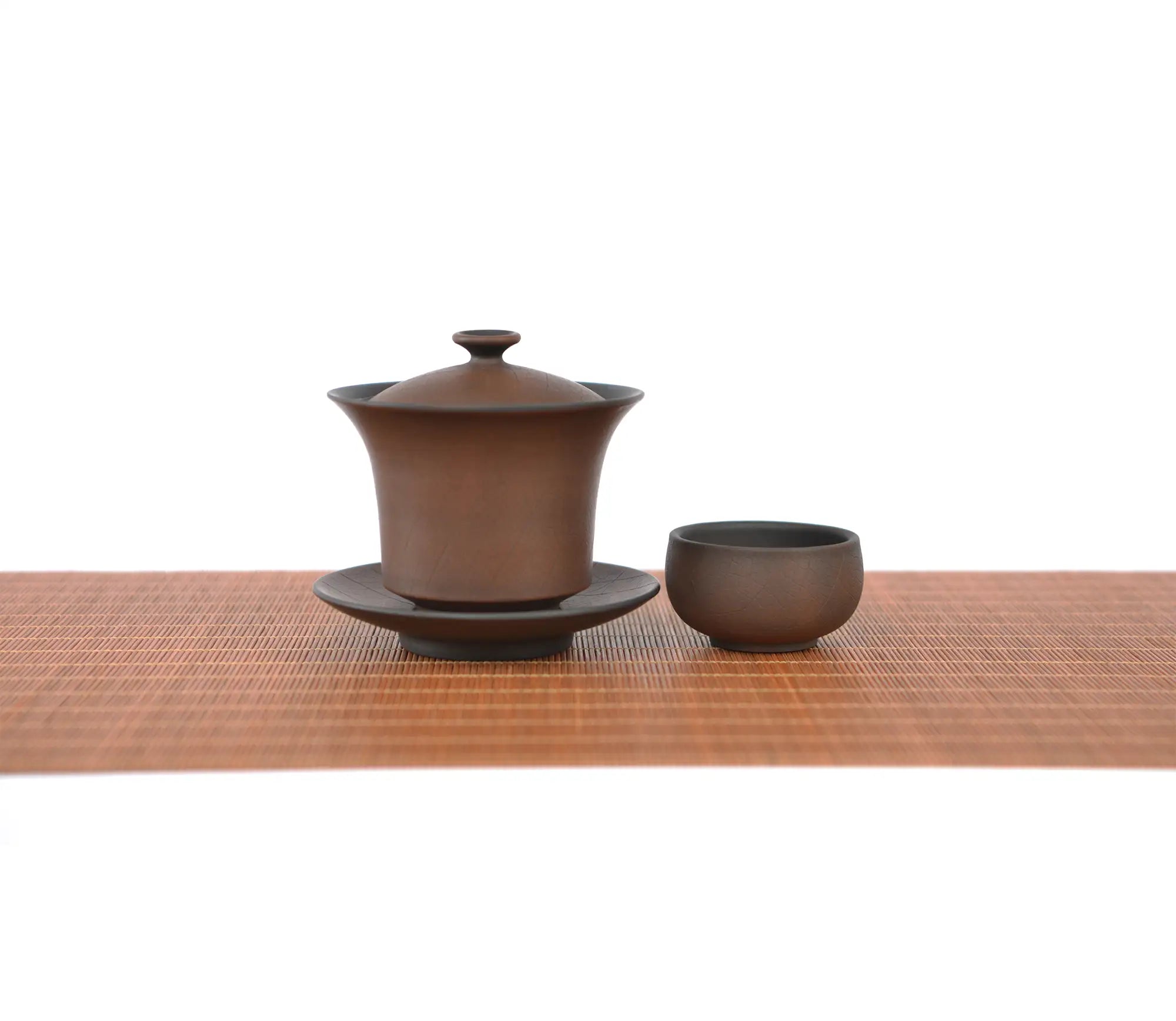 Warm brown bodhi-pattern pottery gaiwan tea cup set with a wood-grain–inspired textured surface, displayed with a matching teacup