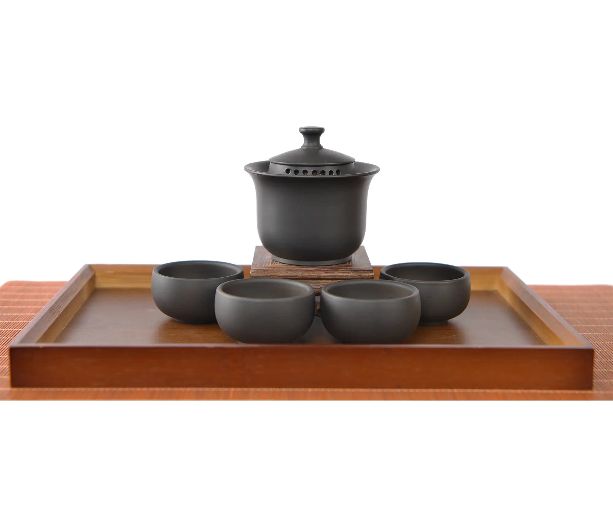 Handcrafted black pottery gaiwan set with finger-grip lid and built-in filter holes, displayed with four matching tea cups.