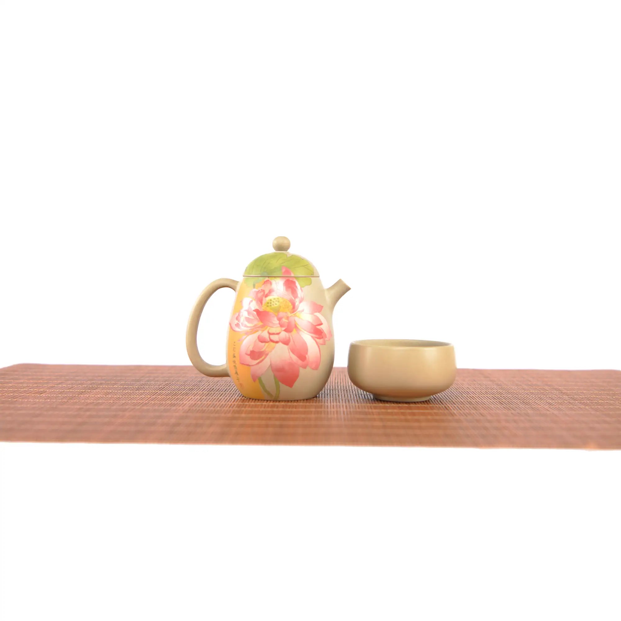 Handcrafted white clay teapot and cup set with hand-carved lotus artwork.