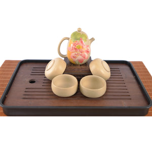 Handcrafted white clay lotus teapot set with four matching cups, featuring a hand-carved lotus floral design.