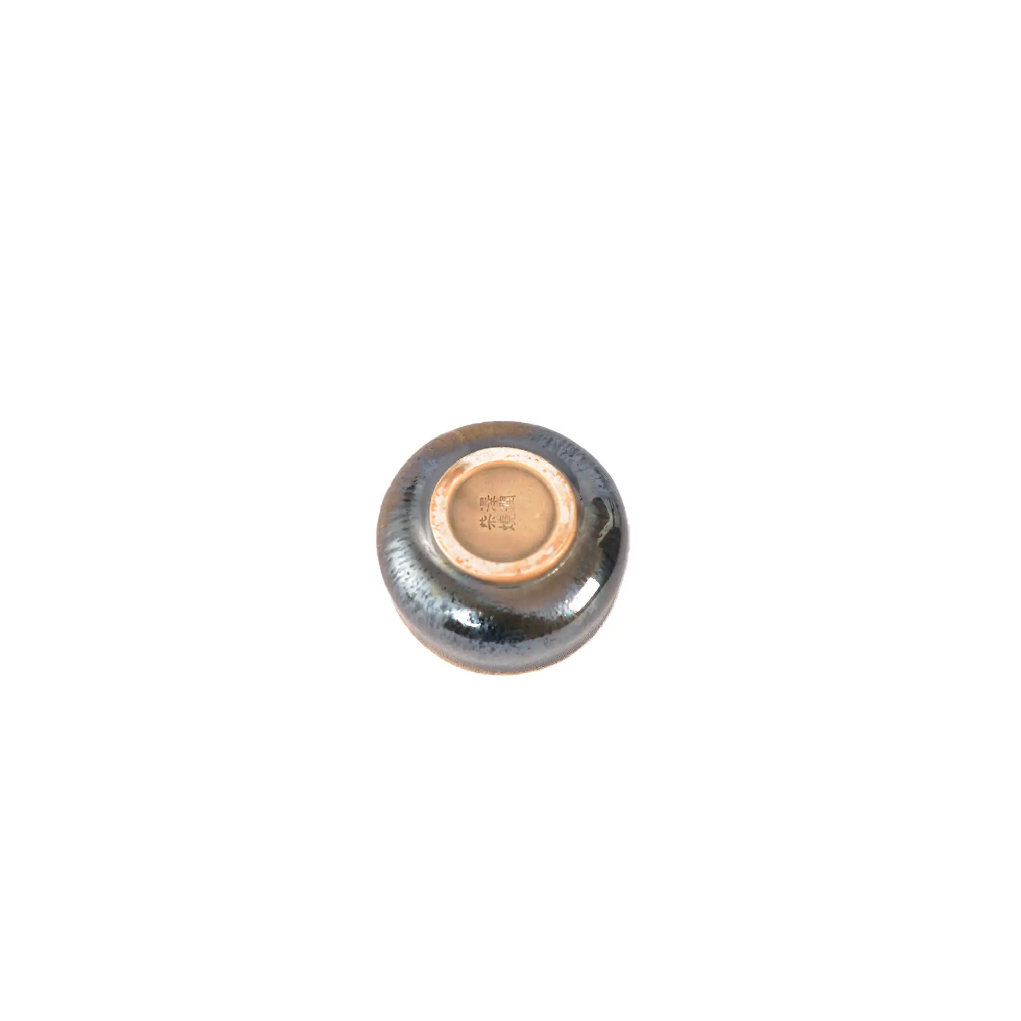 Jianshui zitao wood-fired cup bottom showing natural firing marks and raw clay base