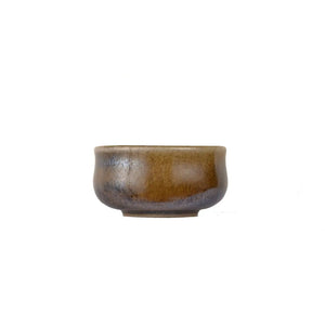 Jianshui zitao wood-fired cup with natural ash deposit and unique surface variation, side view.