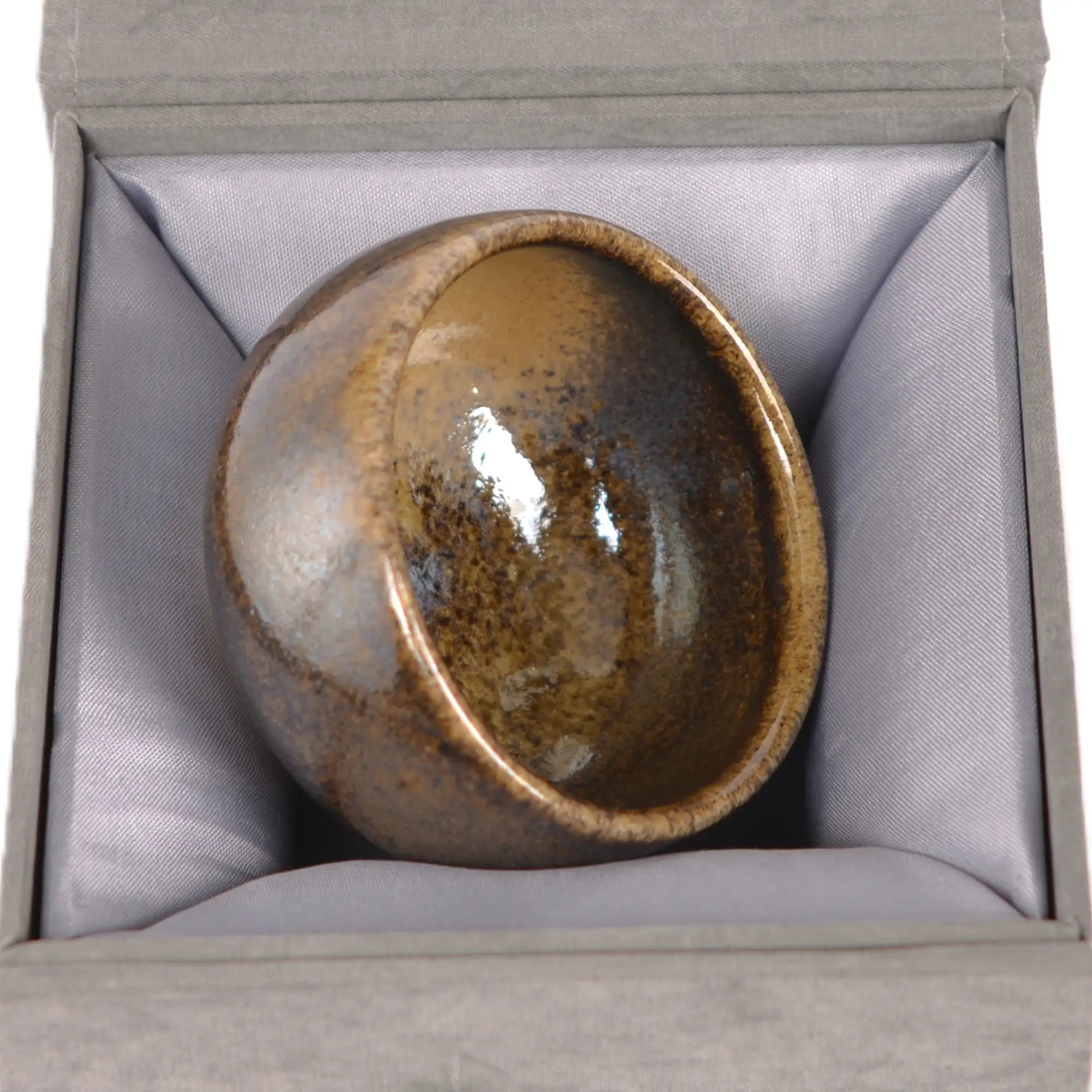 Jianshui zitao wood-fired cup displayed on a gift box, emphasizing its handcrafted kiln-fired character