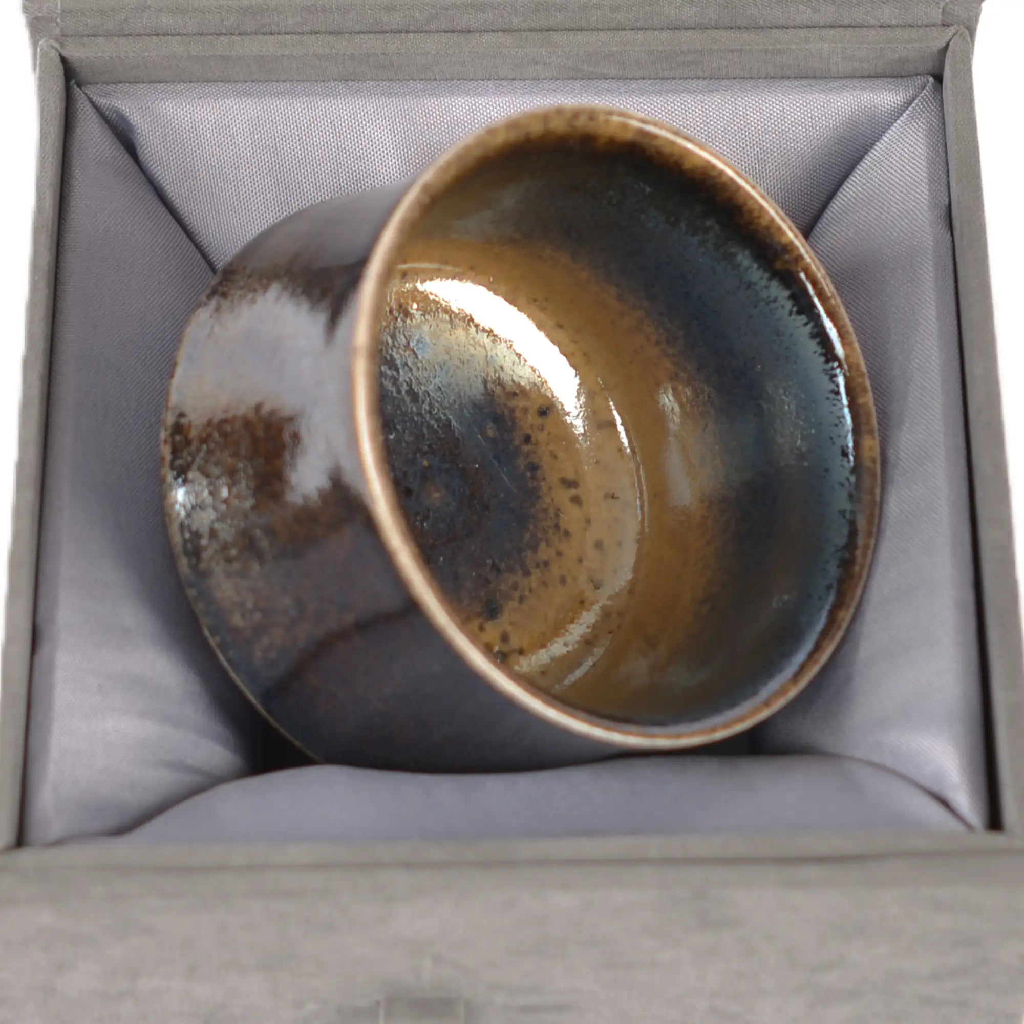 Jianshui zitao wood-fired cup displayed on a gift box, emphasizing its natural wood-fired character